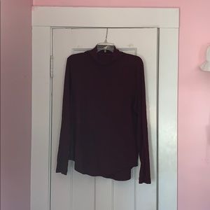 Maroon turtle neck sweater.